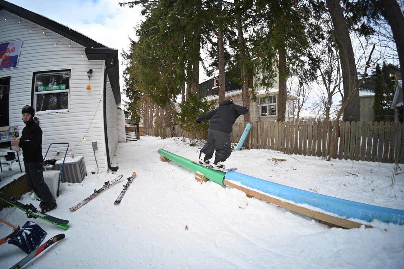 Snowboarding the rail beside the house